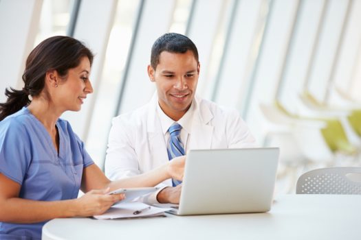 Doctor And Nurse Having Informal Meeting In Hospital Canteen